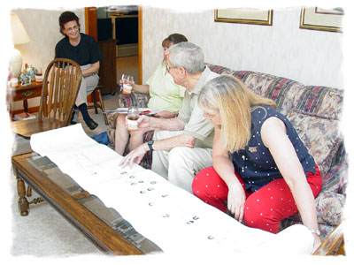 a family reviews their genealogy chart